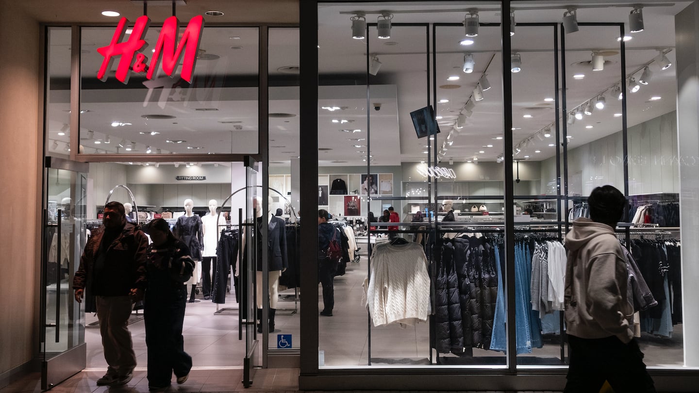 Shoppers walk out of an H&M store at Fashion Valley, an upscale shopping mall.