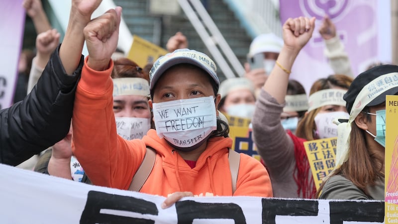 Protestors wear masks saying "We want freedom of transfer" during a rally to call for more rights for migrant workers in Taiwan in 2022.