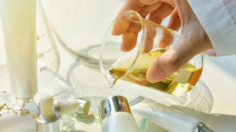 Scientist mixing beauty products in a lab.